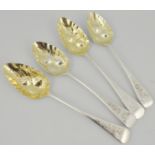 Four various tablespoons, later adapted to berry spoons, embossed and gilded bowls,