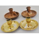 A pair of olive wood travel candlesticks, a pair of brass candlesticks,