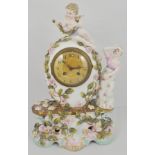 Continental porcelain mantel clock, ovoid urn shape form, cherub finial, an attendant lady,