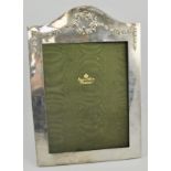 Large silver mounted photograph frame, arched form with applied floral wreath, easel back,