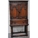 A reproduction oak cupboard.