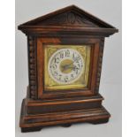 Oak cased mantel clock, triangular pediment, movement striking on a bell, height 25cms.