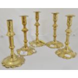 A pair of 18th Century brass candlesticks, height 20cms, and another pair, 19cms.