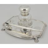 Edwardian silver desk stand, fitted with a single glass well, engraved with cornucopia, paw feet,