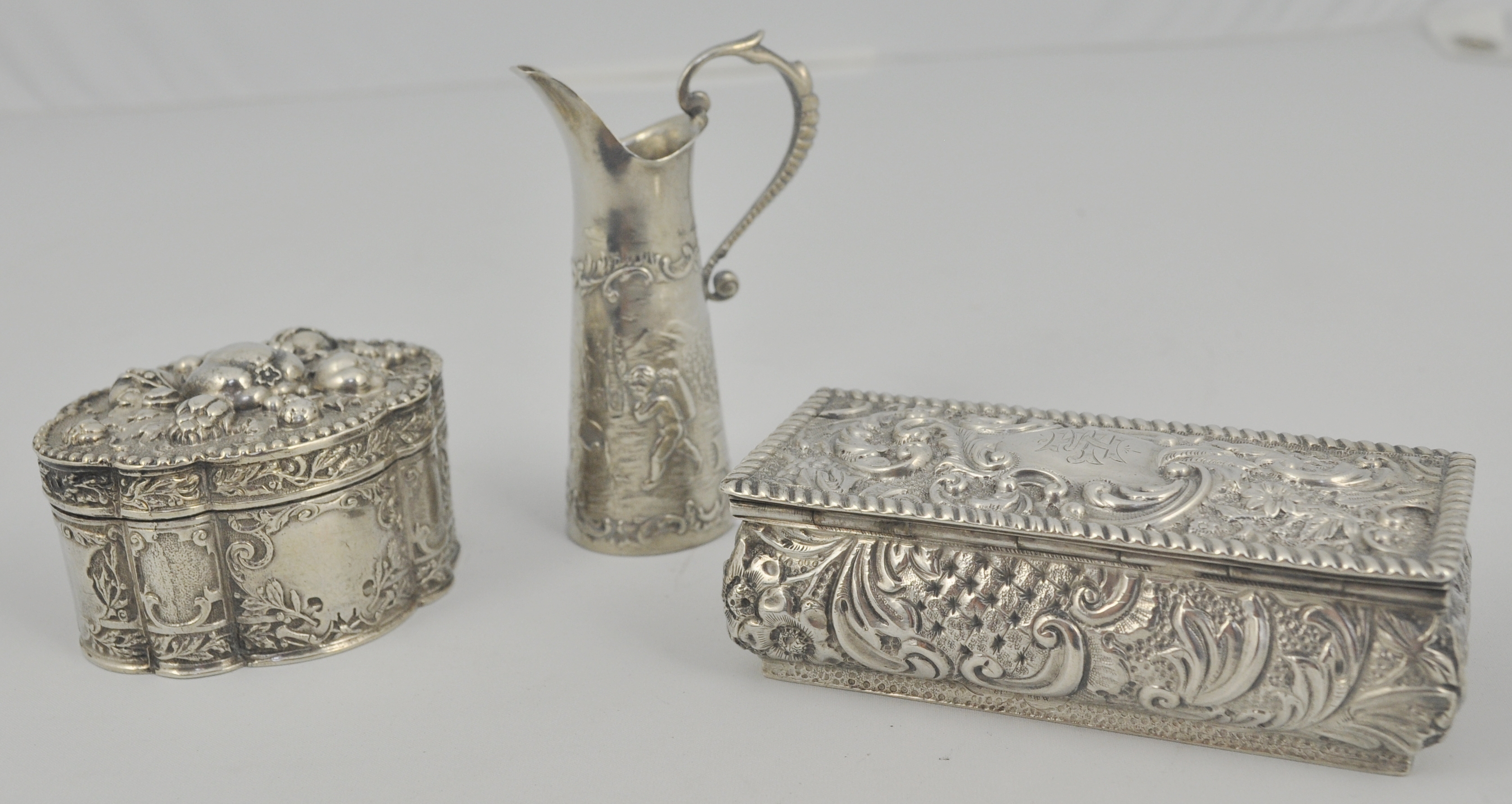 Small silver cased scent bottle, rectangular box and one other, Continental silver miniature jug,