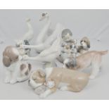 Lladro model, of a child with puppies, 13cms, Lladro swan, two Nao geese and four models of dogs,