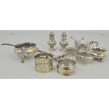 A collection of silver condiments, napkin rings, etc., (12).