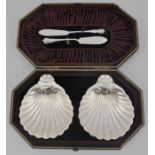 Pair of silver shell butter dishes, SF/AJF, Sheffield, together with associated knives, cased,