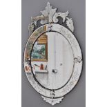 Venetian wall mirror, oval frame with a scrolled pediment, wheel engraved panels,