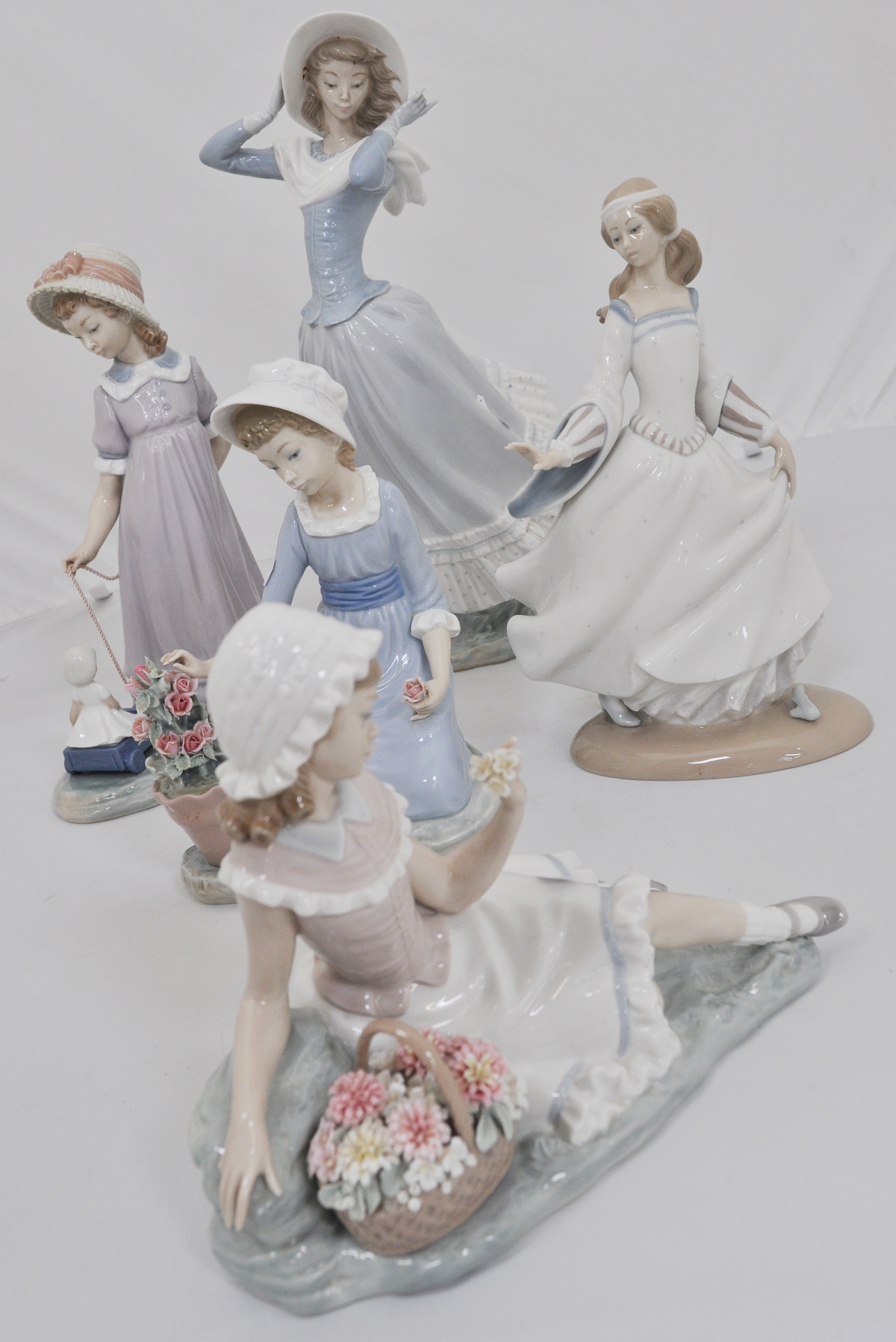 Lladro figure, Girl in a bonnet on a windy day, 37cms and four other Lladro figurines, (5).