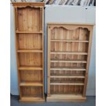 A pair of pine open bookcases, adjustable shelves, width 82cm and another open bookcase, (3).
