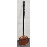 A Victorian copper warming pan, ebonised handle, 104cm.