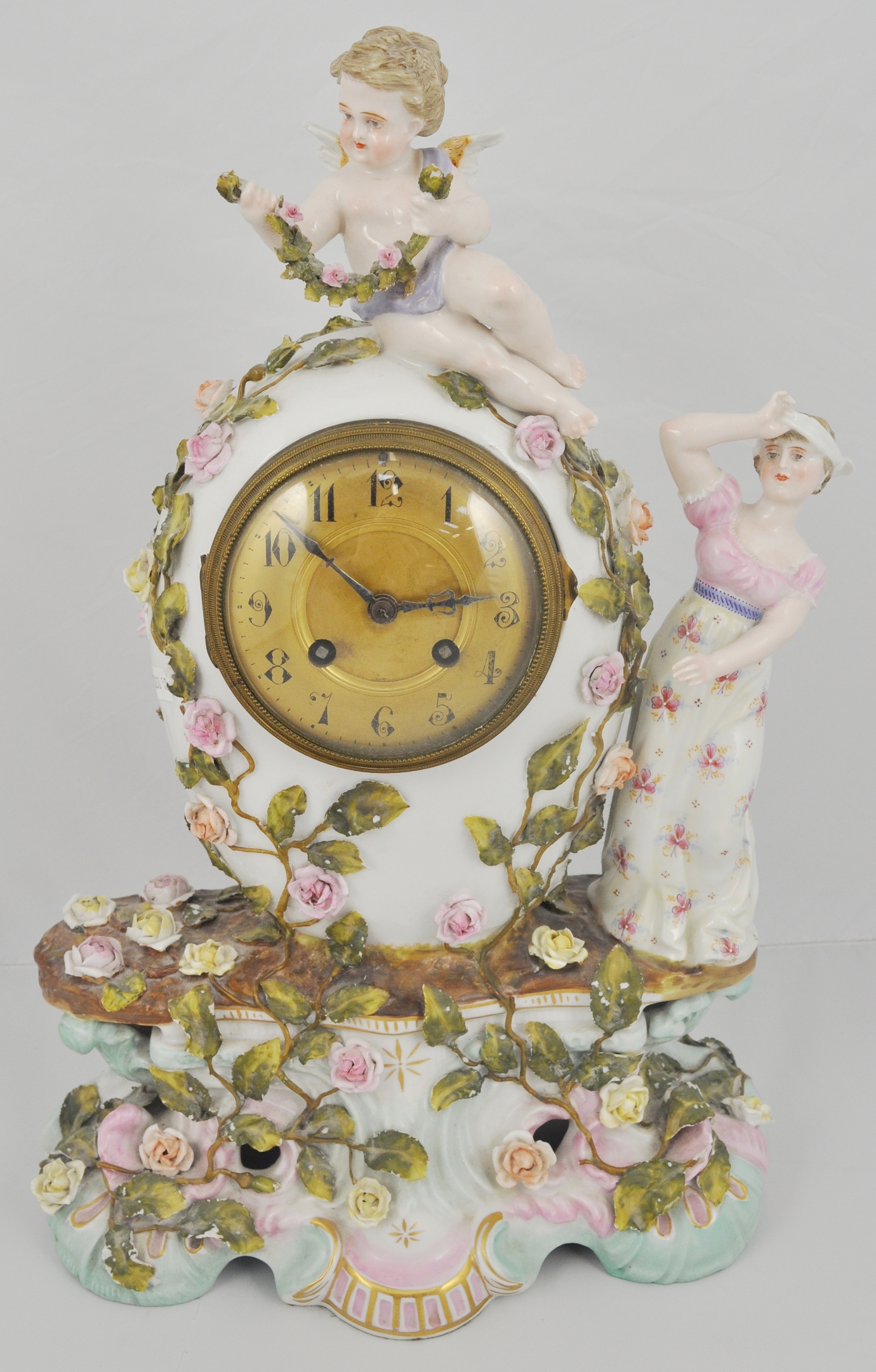 Continental porcelain mantel clock, ovoid urn shape form, cherub finial, an attendant lady,