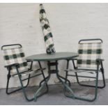Set of four folding garden chairs and a table and a parasol.