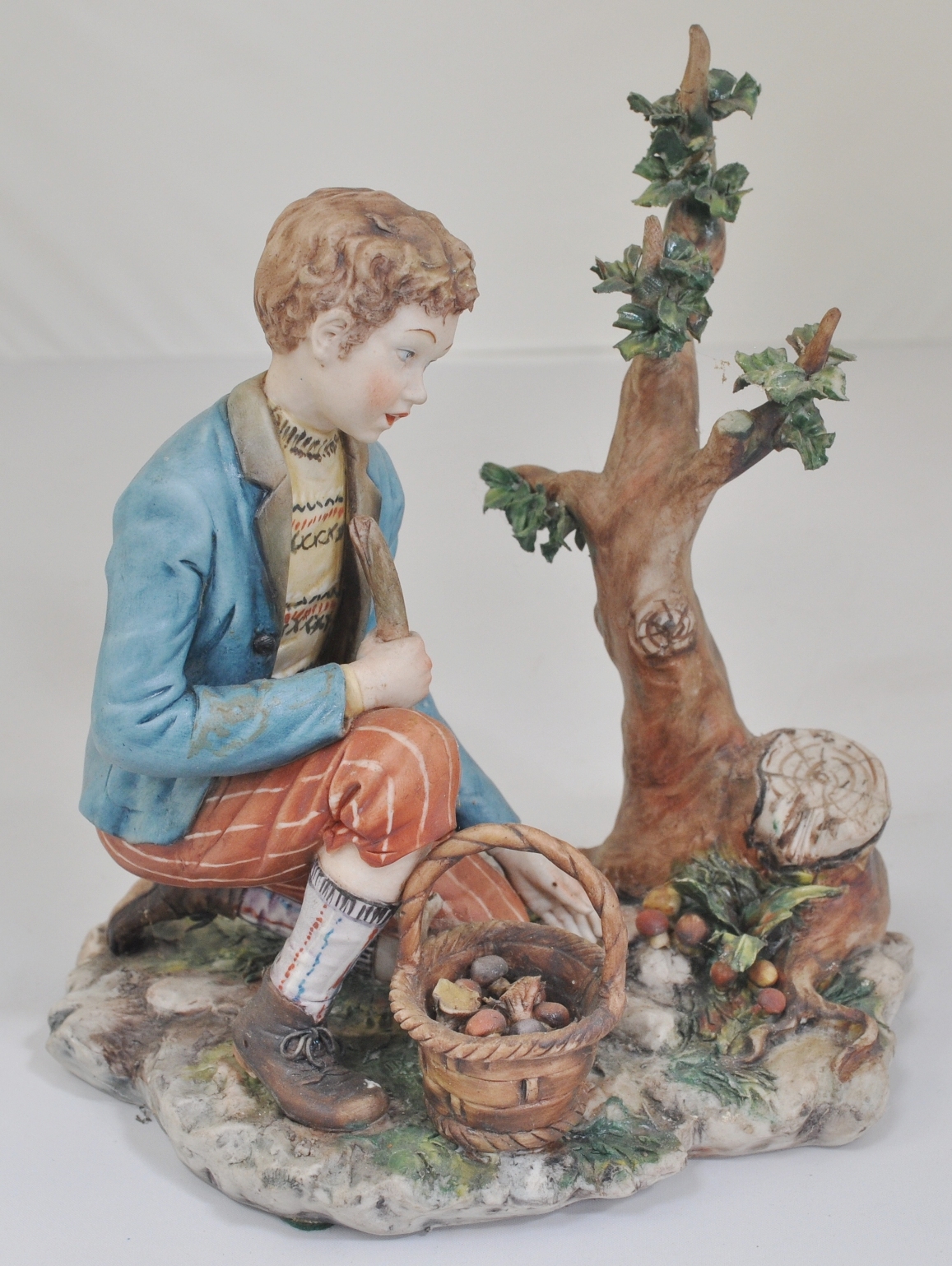 Pair of Capodimonte porcelain figures, Boy and Girl collection fruit, signed Volta, height 19cm,