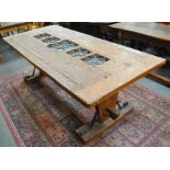 A handcrafted refectory table, the centre with insets with metal covers,