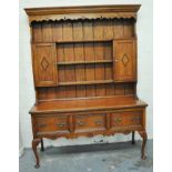 George III style oak dresser, panelled back with shelves and cupboard, the base with the drawers,