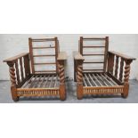 A pair of oak reclining chairs, with barley-twist supports, 70cm.