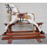 A carved and painted wood rocking horse, trestle base, 114cm.