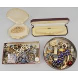 Two tins of various costume jewellery, (quantity).