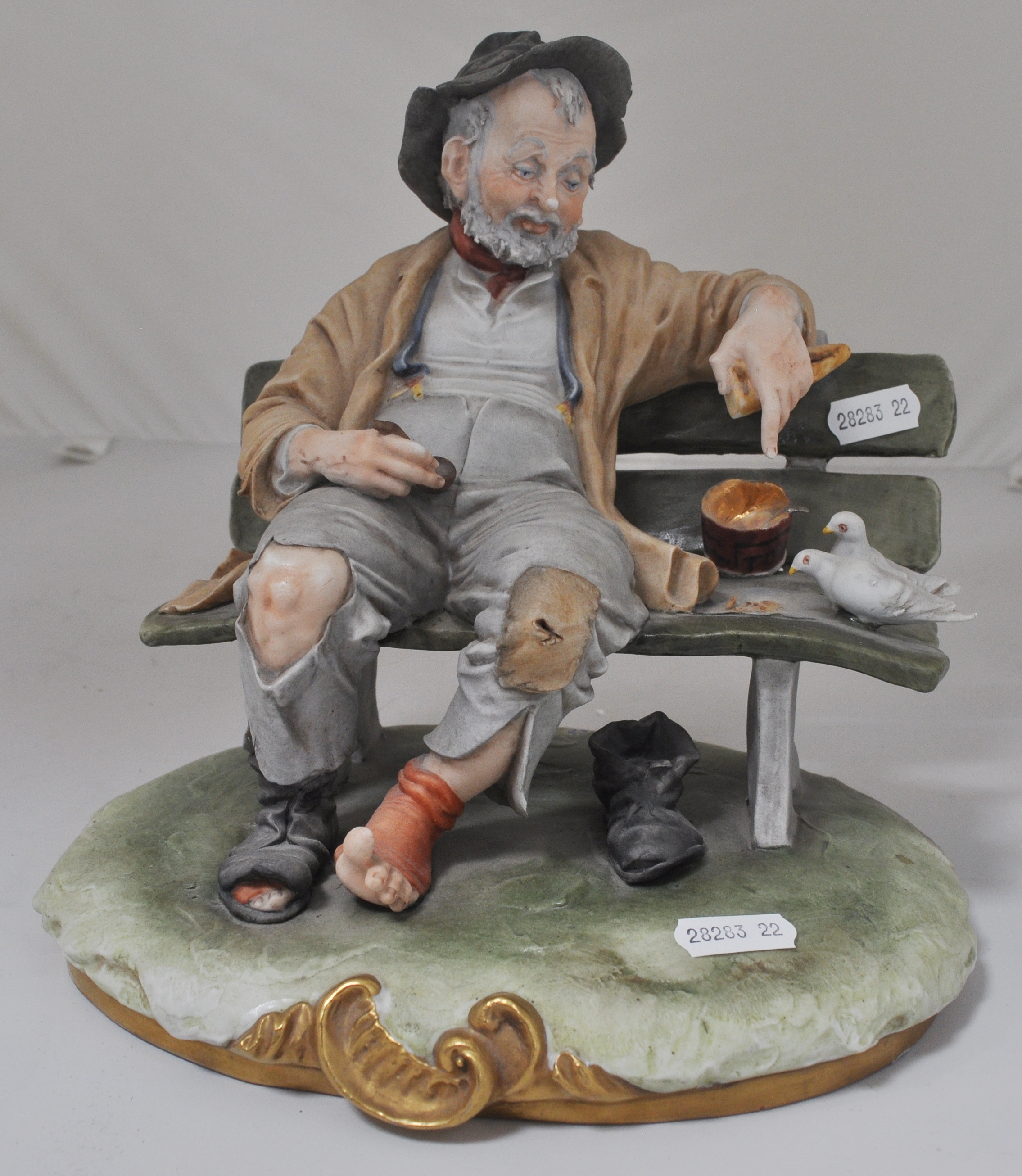 Capodimonte porcelain model, figure on a bench, signed B Merli, height 22cm, another similar, (2).