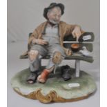 Capodimonte porcelain model, figure on a bench, signed B Merli, height 22cm, another similar, (2).