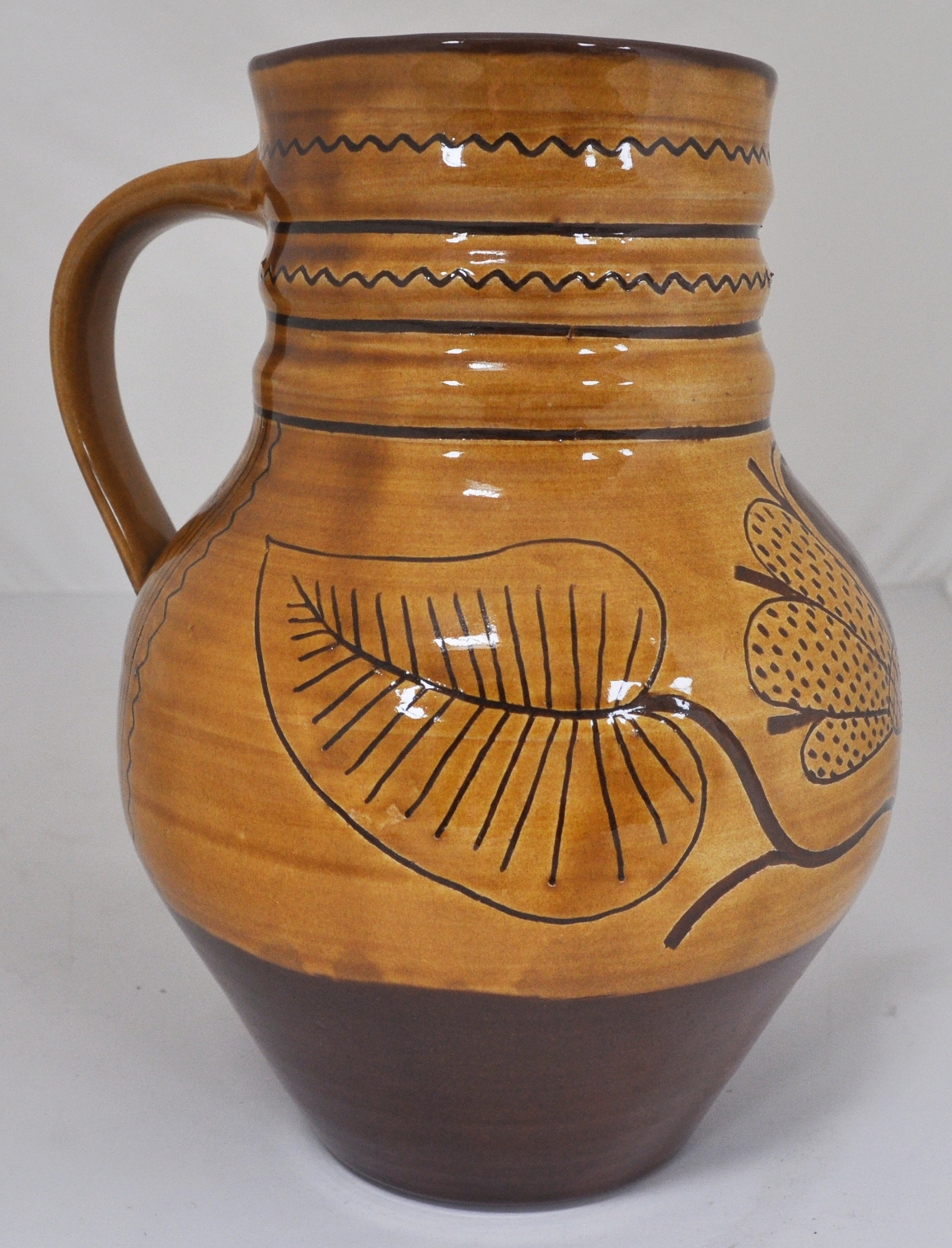 "Wells" terracotta glazed jug, 23cm, jar, two dishes and a bowl, (5).