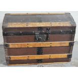19th Century domed travelling trunk, with strapping and a bamboo and cane crib, (2).