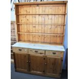 A modern pine dresser with three drawers to the base, and three cupboards under, 138cm.