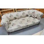 A Chesterfield style three seater sofa, Edwardian walnut legs, 190cm.