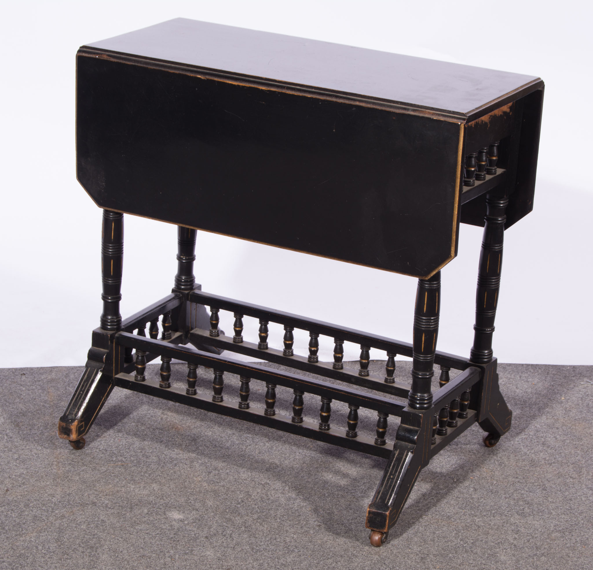 Aesthetic movement ebonised and gilt Sutherland table, rectangular top with canted corners,