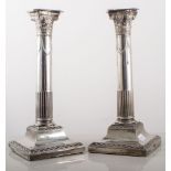 Pair of silver Corinthian column candlesticks, H.E.