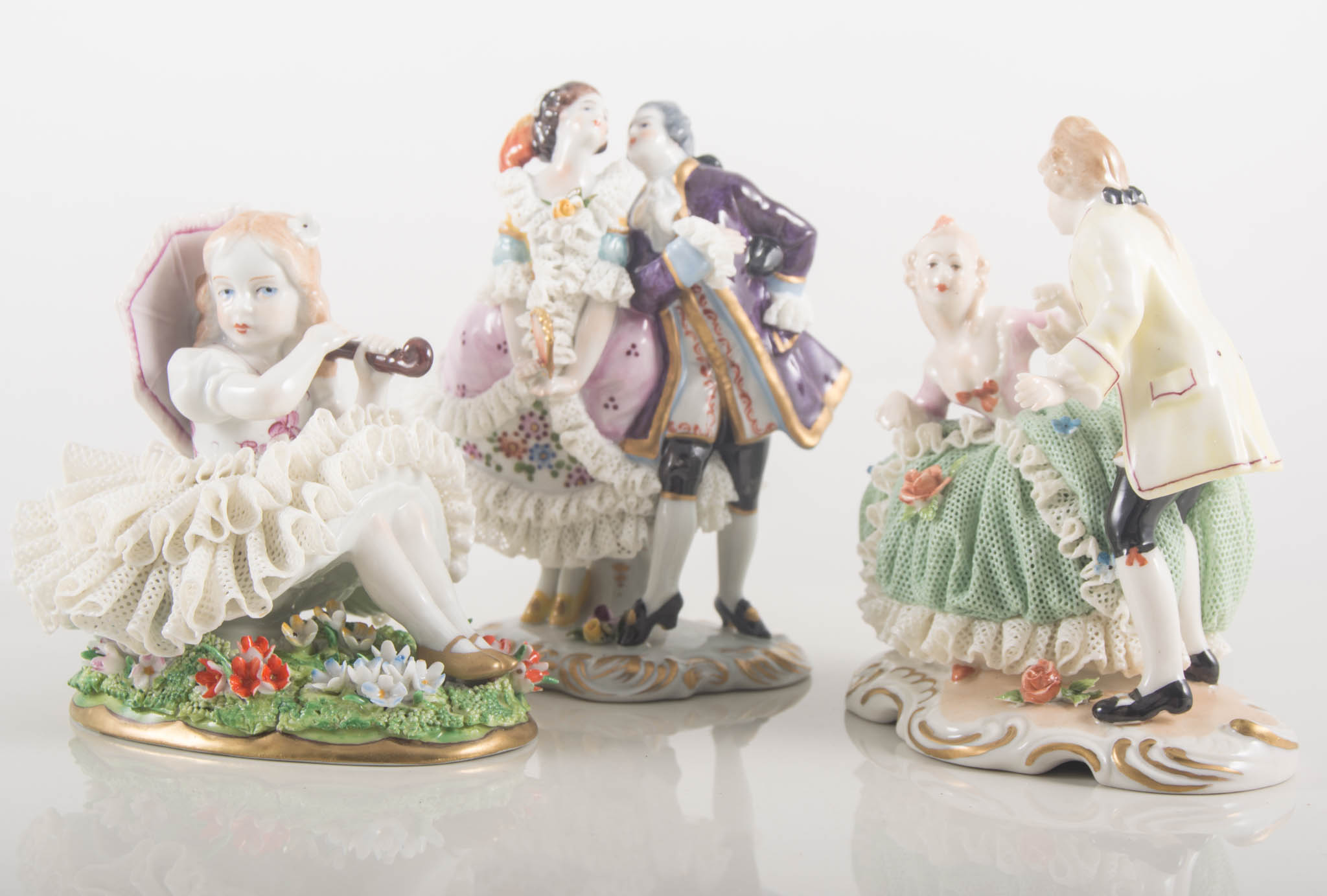 Sitzendorf porcelain group, seesaw, length 20cm, and four other continental porcelain figures, (5).