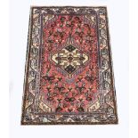 Small Persian mat, central lozenge medallion on a pale ground, red ground field within guards,