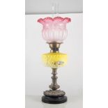 Victorian oil lamp, with cranberry shade, height 63cm.