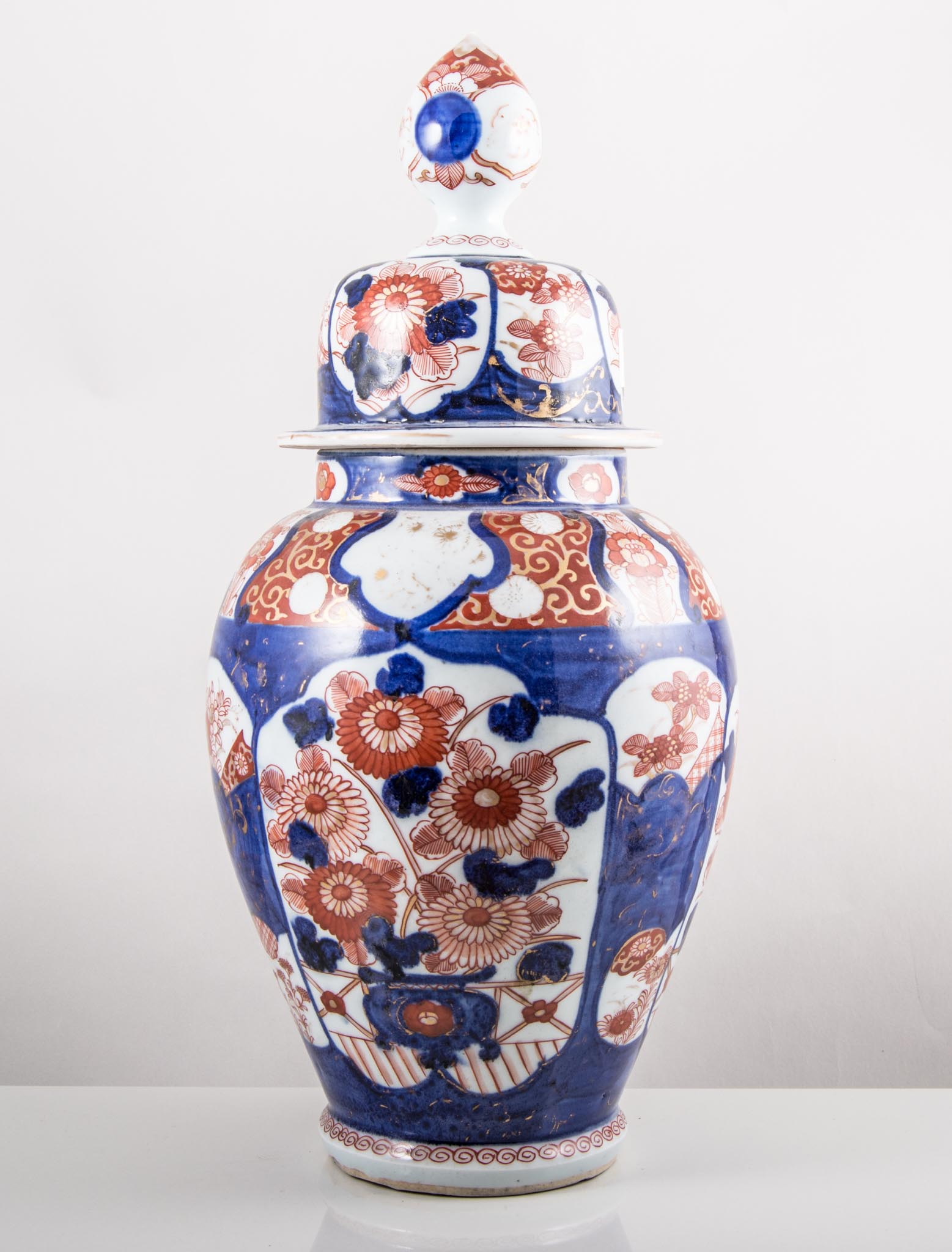 Pair of Japanese Imari baluster vases and covers, 42cms and a similar vase, 30cms, (3).