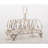 Silver six-section toast rack, beaded outlines on four scrolled feet, Birmingham 1883, height 15cm,