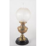 Edwardian brass pedestal oil lamp, circular base, etched glass shade, with chimney, height 54cm.