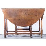 Joined oak small gateleg table, oval top with two fall leaves, turned supports, length 106cms.