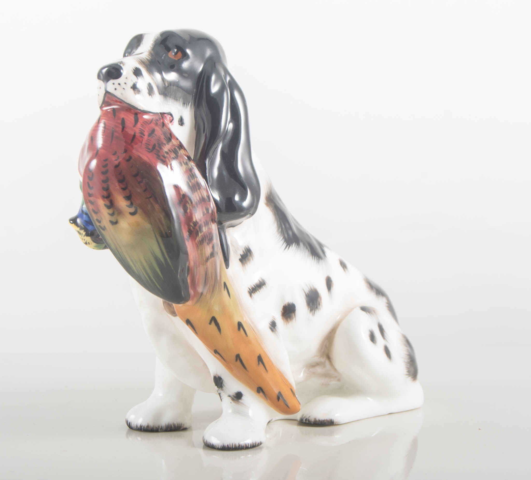 Royal Doulton model of a seated dog with a pheasant HN1138, height 14cm.