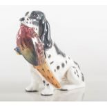 Royal Doulton model of a seated dog with a pheasant HN1138, height 14cm.