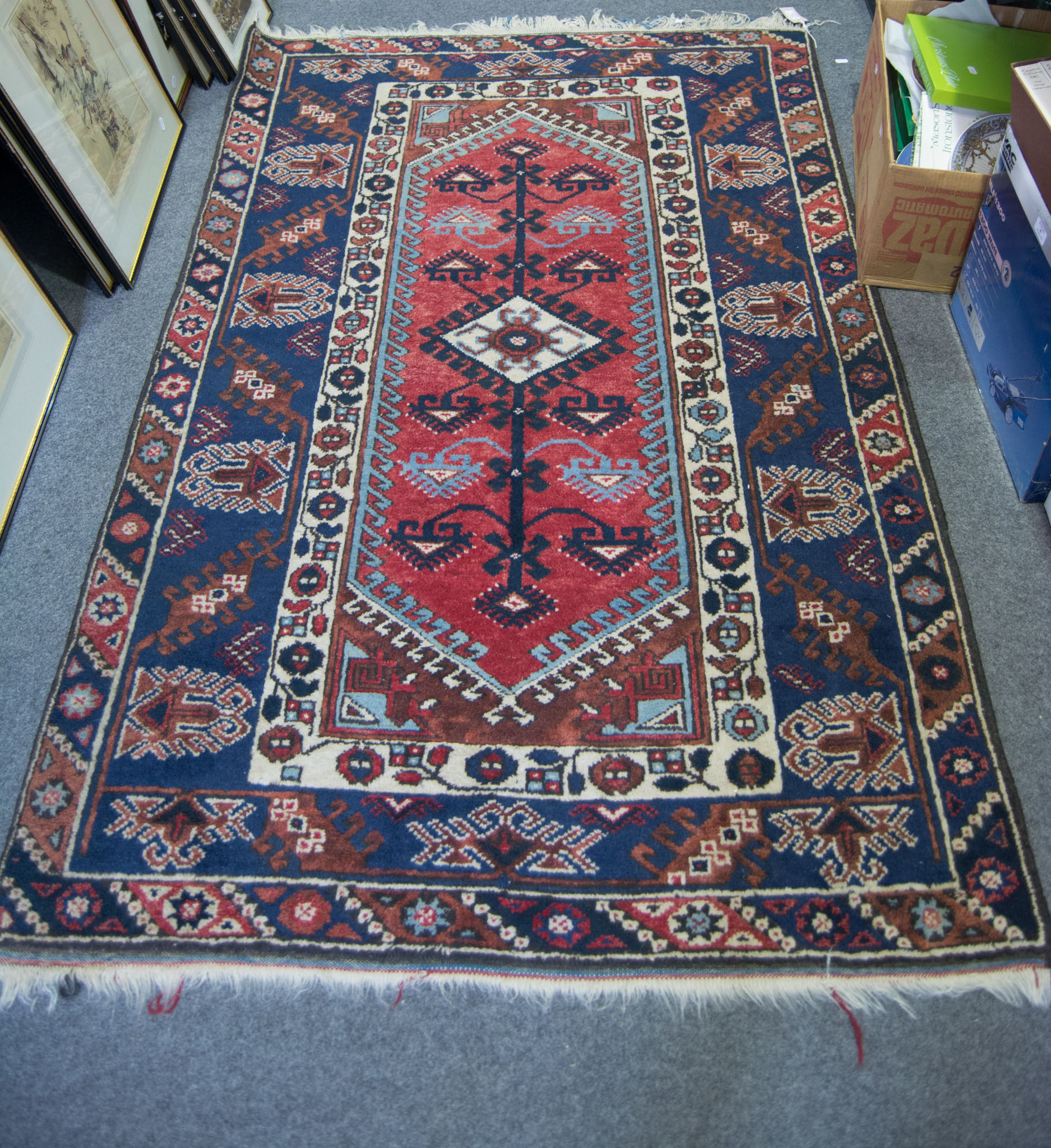 Caucasian rug, central lozenge medallion on a pole, red field, border within guards,