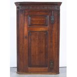 George III oak hanging corner cupboard, dental and cavetto cornice, blind fretwork frieze,