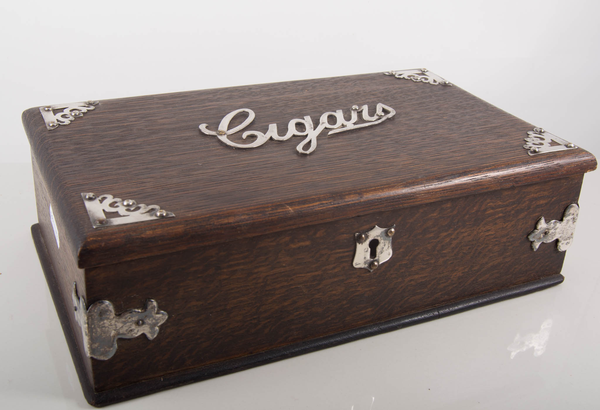 An oak cigar box having plated metal spandrels to the corners and "Cigars" in script across the