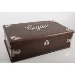 An oak cigar box having plated metal spandrels to the corners and "Cigars" in script across the