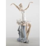 A porcelain D'Argla seated ballerina, 31cms.