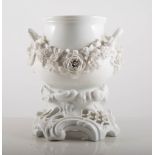 Meissen white porcelain two--handled bowl on stand, crested with floral festoons, 22cm.