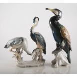 Continental porcelain model of a Cormorant, 29cm, and a group of two Herons, (2).