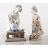 Three Lladro figures, girl with oranges, boy playing with a dog and a Geisha girl with flowers. (3).