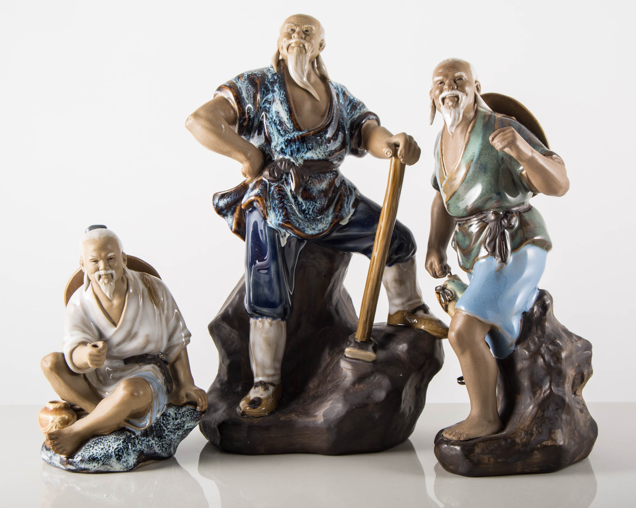 Three Chinese stone-glazed figures, 24cm and smaller, (3).